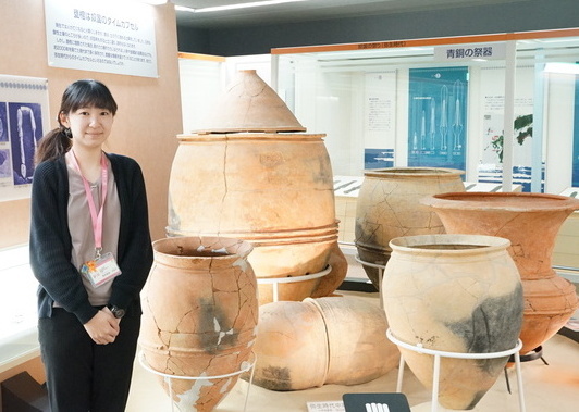 写真:甕棺の前に立つ熊埜御堂さん